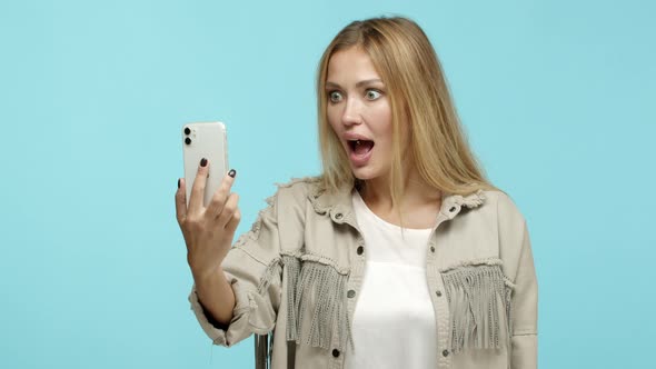Slow Motion of Blond Stylish Woman Checking Out Something Cool Online Stare Surprised at Smartphone
