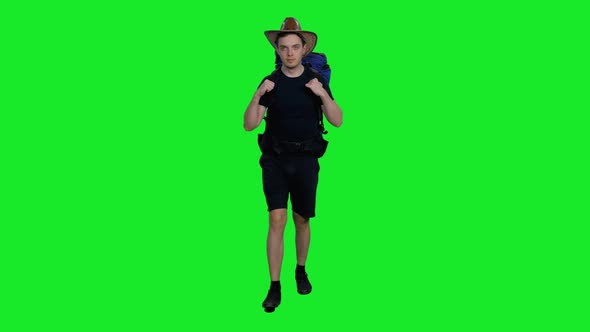 Young Hiker Man in Cowboy Hat Walking with Backpack against Green Screen