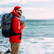 Tourist with a backpack on the background of the sea, rear view. - PhotoDune Item for Sale