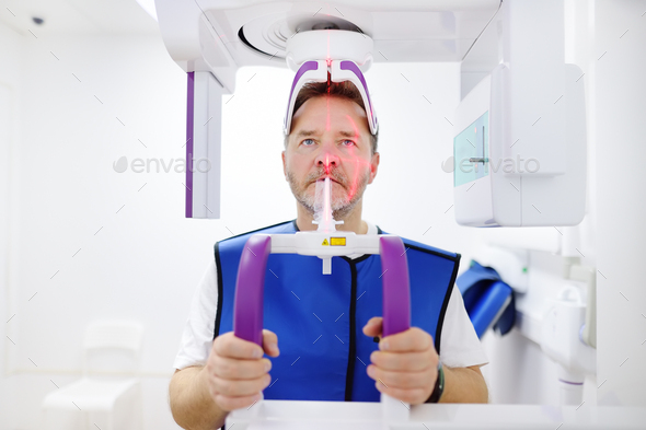 Man patient during a panoramic radiography in dentistry clinic. Modern dental equipment