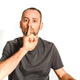 Man in studio asking for silence with a wave of his hand putting a finger on his lips - PhotoDune Item for Sale