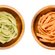 Tagliatelle pasta in different colors, twisted into nests, in bowls - PhotoDune Item for Sale