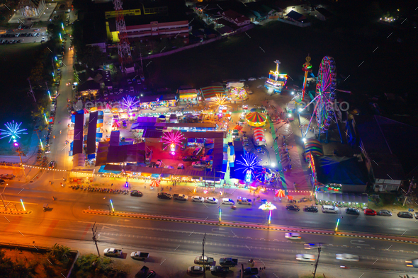 Aerial top view of amusement park in night temple fair, and local ...