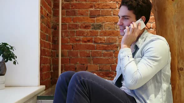 Man Talking on Mobile Phone Attending Call Loft Interior alt