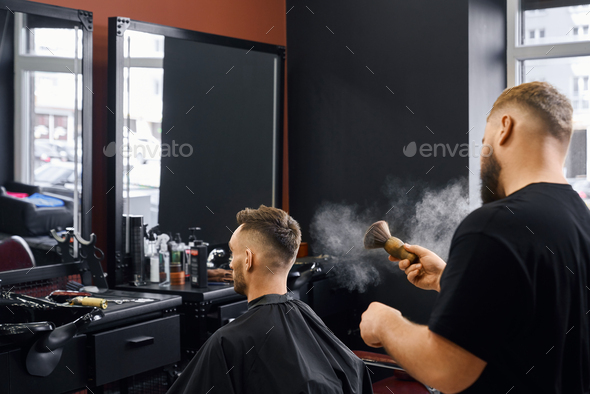 Swag barber in black working with client using big brush.