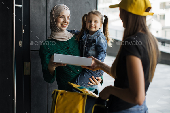 Young delivery woman with yellow cap and backpack that new normal style by express service