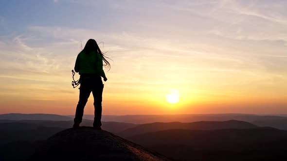Slow Motion of Happy Woman Climber Dancing on Top of Mountain at Sunset
