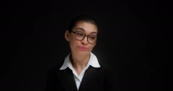 Business Woman with Glasses Shrugs Her Shoulders