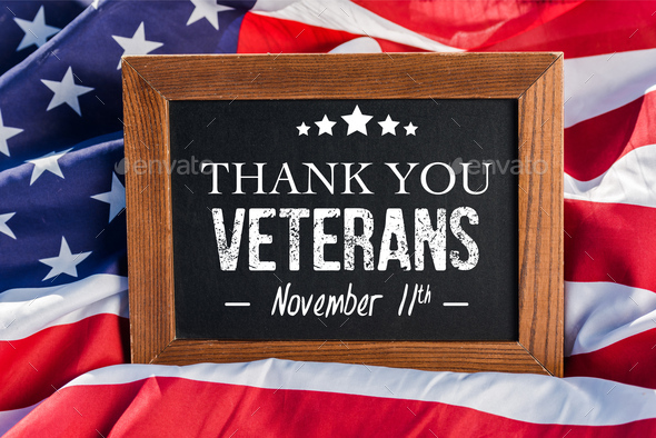 chalkboard with thank you veterans illustration on american flag with stars and stripes