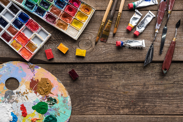 top view of palette with Gouache paints and paintbrush on white background  Stock Photo by LightFieldStudios