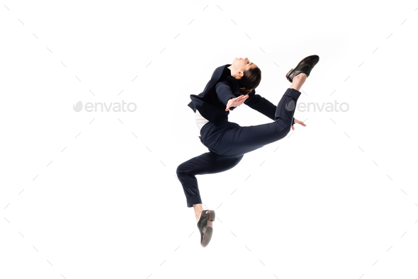 graceful businesswoman in formal wear jumping in dance isolated on white