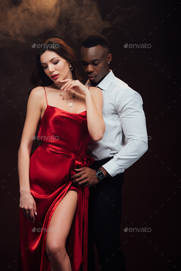 Beautiful Sensual Interracial Couple In Formal Wear Posing On Black