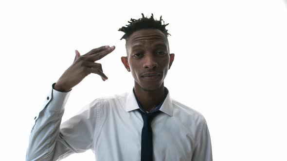 Black Man Gestures a Gun To His Temple and Experiencing Stress alt