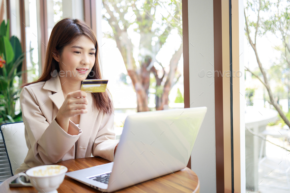 Attractive Asian businesswoman using credit card for goods payments shopping online