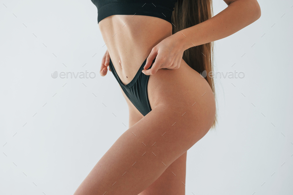 Close up view. Woman in underwear with slim body type is posing in the  studio Stock Photo by mstandret