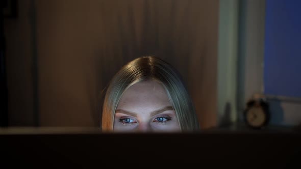 Woman Peeking Out Computer Monitor at Night. Crop View of Beautiful Female Sitting at Night at alt