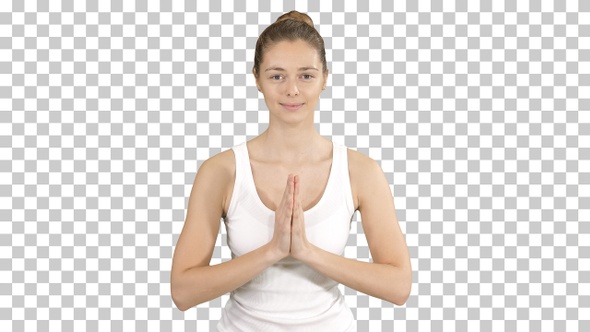 Young yogi woman practicing yoga making namaste gesture, working alt