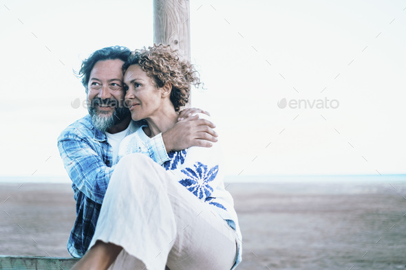 Blue mood of romantic couple enjoy time together outdoor with winter beach in background