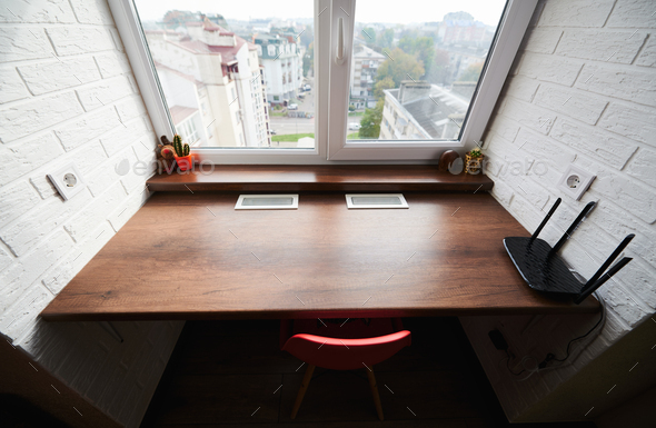 Design of desk in small space in front of window.