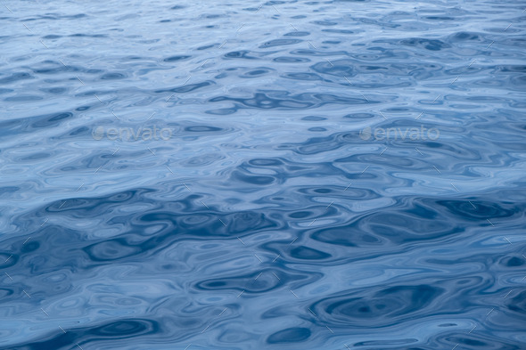 Sea water surface calm with small ripple. Still ocean, deep blue color background. Aegean Sea.