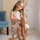 Little girl riding a toy wooden horse at home - PhotoDune Item for Sale