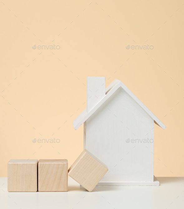 Model of a white wooden house. Real estate tax payment concept