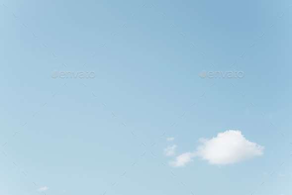 White cloud against blue clear sky, heavenly minimalistic landscape, rule of thirds. Copy space
