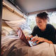 Young woman using laptop in camper - PhotoDune Item for Sale