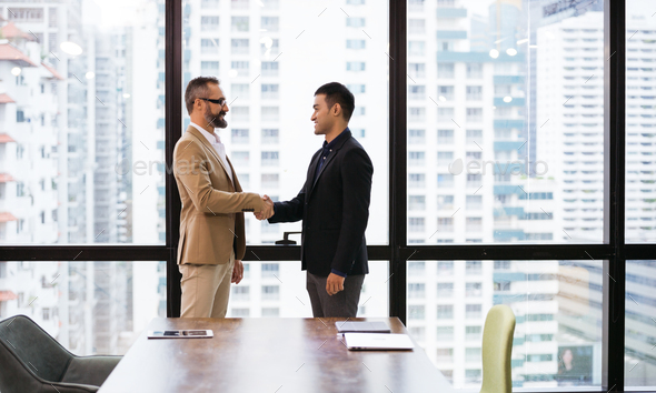 Business man handshaking with customer to greeting or dealing agreement