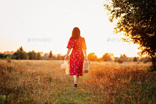 Nature Impact Wellbeing. Woman in red dress enjoying nature.