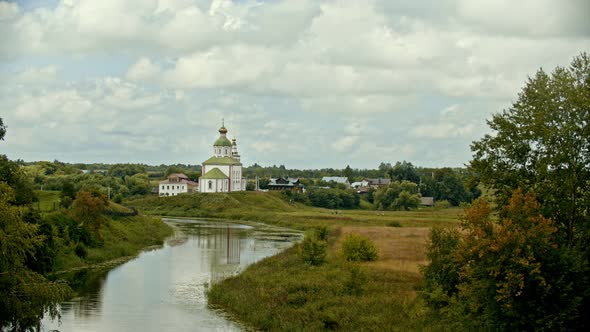 Christian Church in the Village - River on a Foreground - Suzdal, Russia - Time Lapse alt