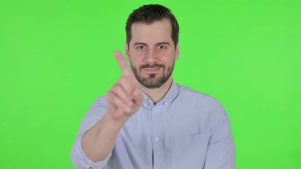 Portrait of Man Showing No Sign By Finger Denial Green Screen alt