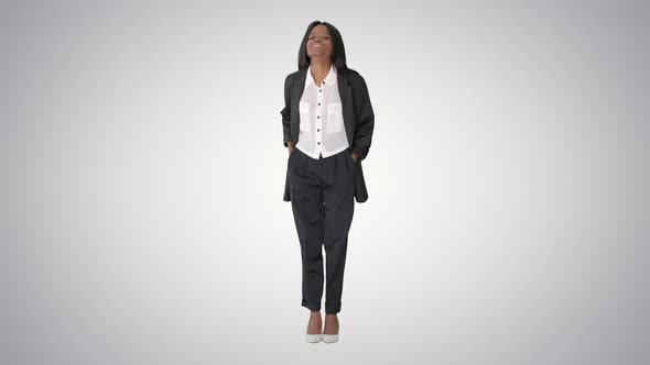 Confident Smiling African American Businesswoman Putting Hands in Her Pockets on Gradient Background alt