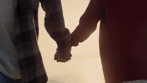 Couple Holding Hands at Sea Beach alt