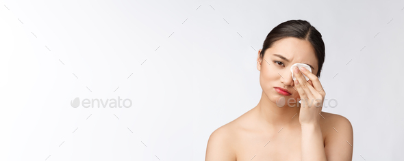 skin care woman removing face makeup with cotton swab pad - skin care concept. Facial closeup of