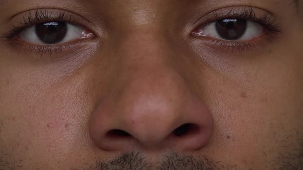 Extreme Close Up Darkskinned Guy Playing with Nosels Smiling Slow Motion alt