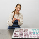 Smiling pastry chef holding freshly made purple macaron - PhotoDune Item for Sale