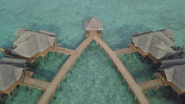 Aerial view of luxury bungalows on water, Island resort villas above sea, Maldives from drone