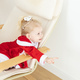 Child girl dressed in christmas dress with cochlear implants having fun at home - PhotoDune Item for Sale