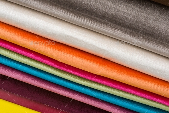 Samples of colorful interior fabrics. Book of fabrics for curtains, upholstery.