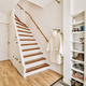 Narrow hallway with closet and clothes hanger next to stairs - PhotoDune Item for Sale