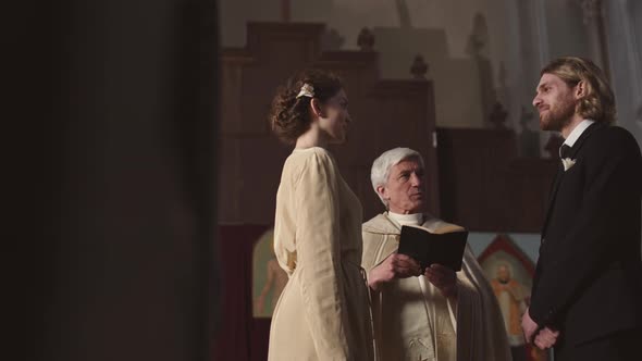 Bride and Groom Pronouncing Wedding Vows in Church alt