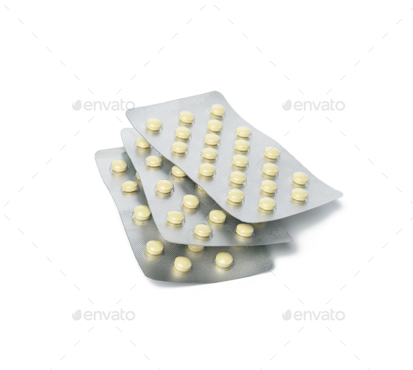 Two packs of round pills in blister pack isolated on white background
