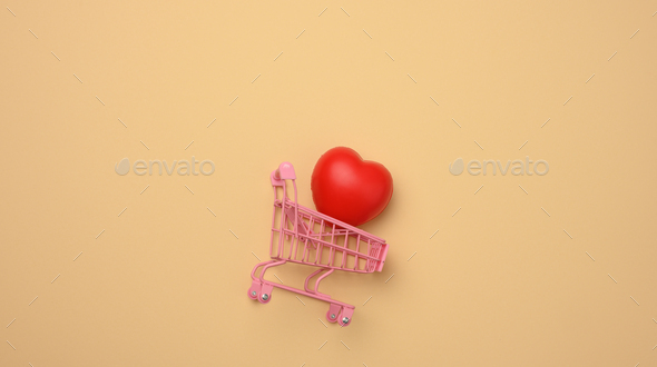 Red heart in a miniature metal trolley from the store