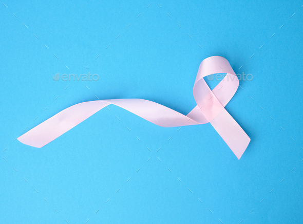 Pink silk ribbon in the shape of a loop on a blue background Stock Photo by  ndanko