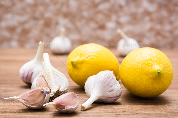 Garlic and lemon on a wooden table. Alternative medicine. Lower cholesterol