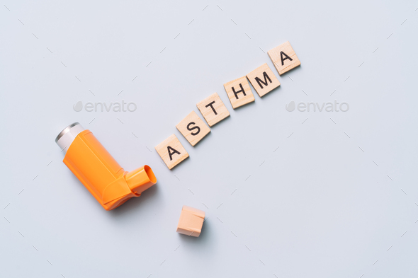 Orange inhalation balloon next to the word asthma - Stock Photo - Images