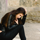 Sad young woman sitting on the floor when she is tired of fighting her problems - PhotoDune Item for Sale