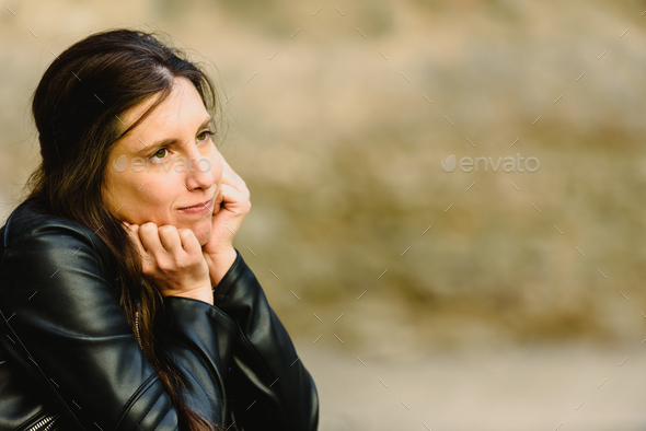 Serious and doubtful young woman with unsure face - Stock Photo - Images