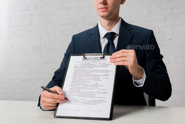 cropped view of realtor holding clipboard with lease agreement lettering on white - Stock Photo - Images